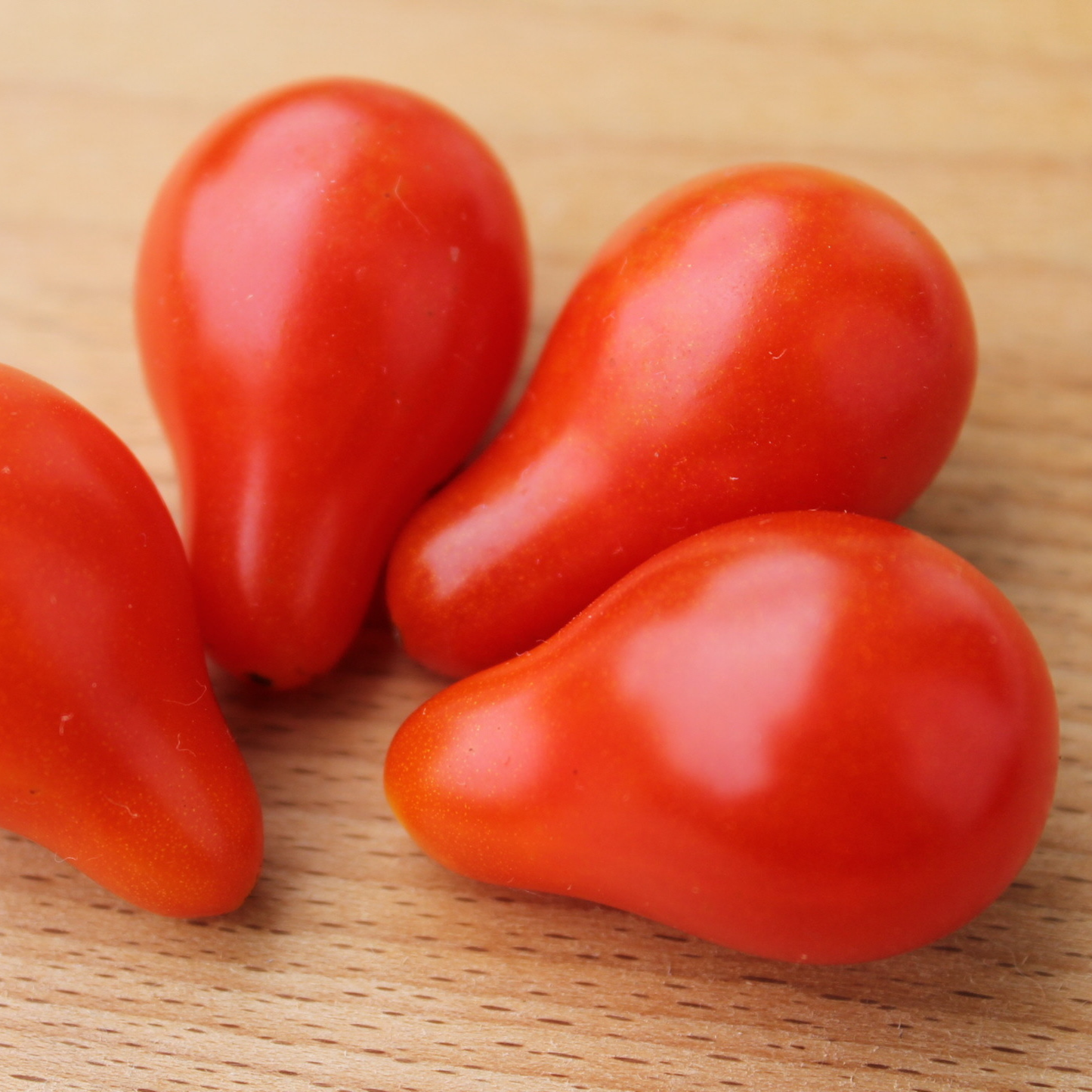 red pear tomatoes on a wooden board