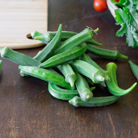 Freshly harvested Clemson Spineless okra pods on a table