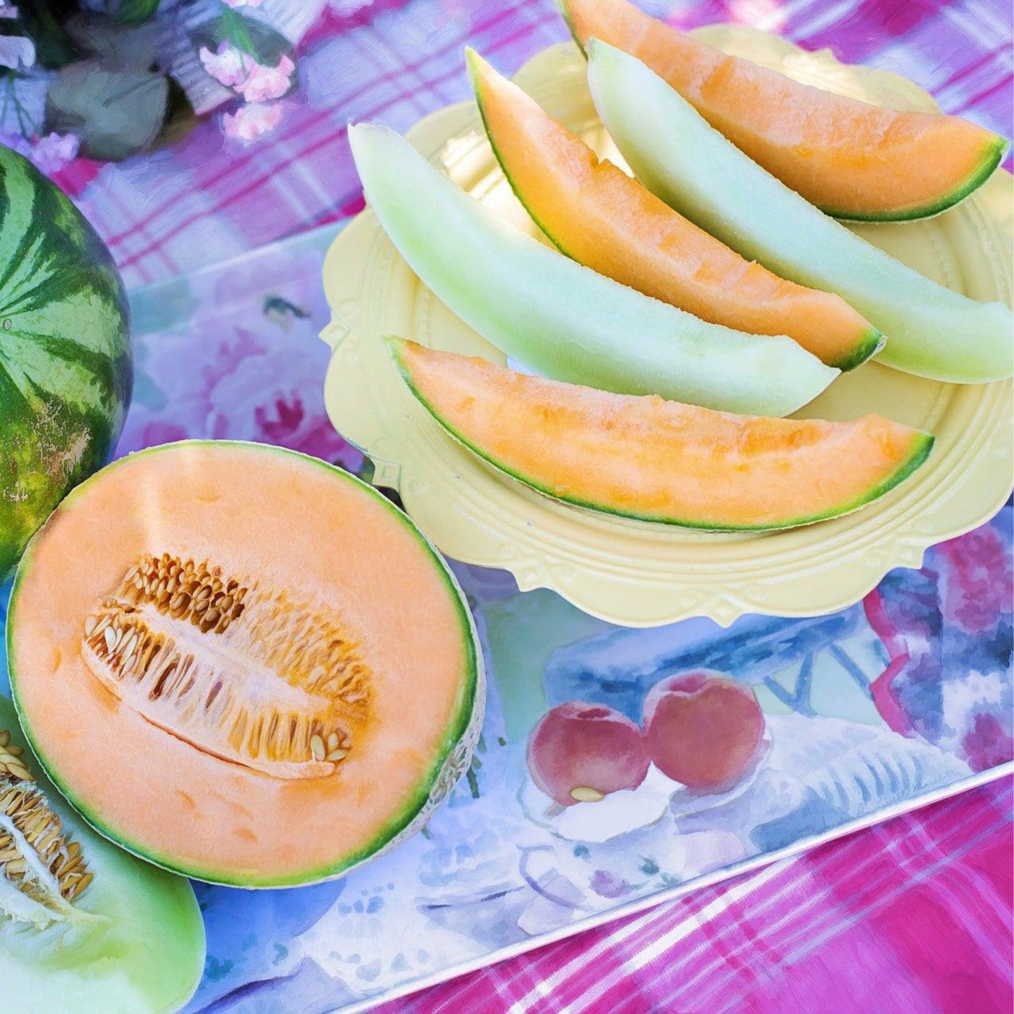 Honey Dew Orange Flesh melon cut open with fresh orange and green melon slices
