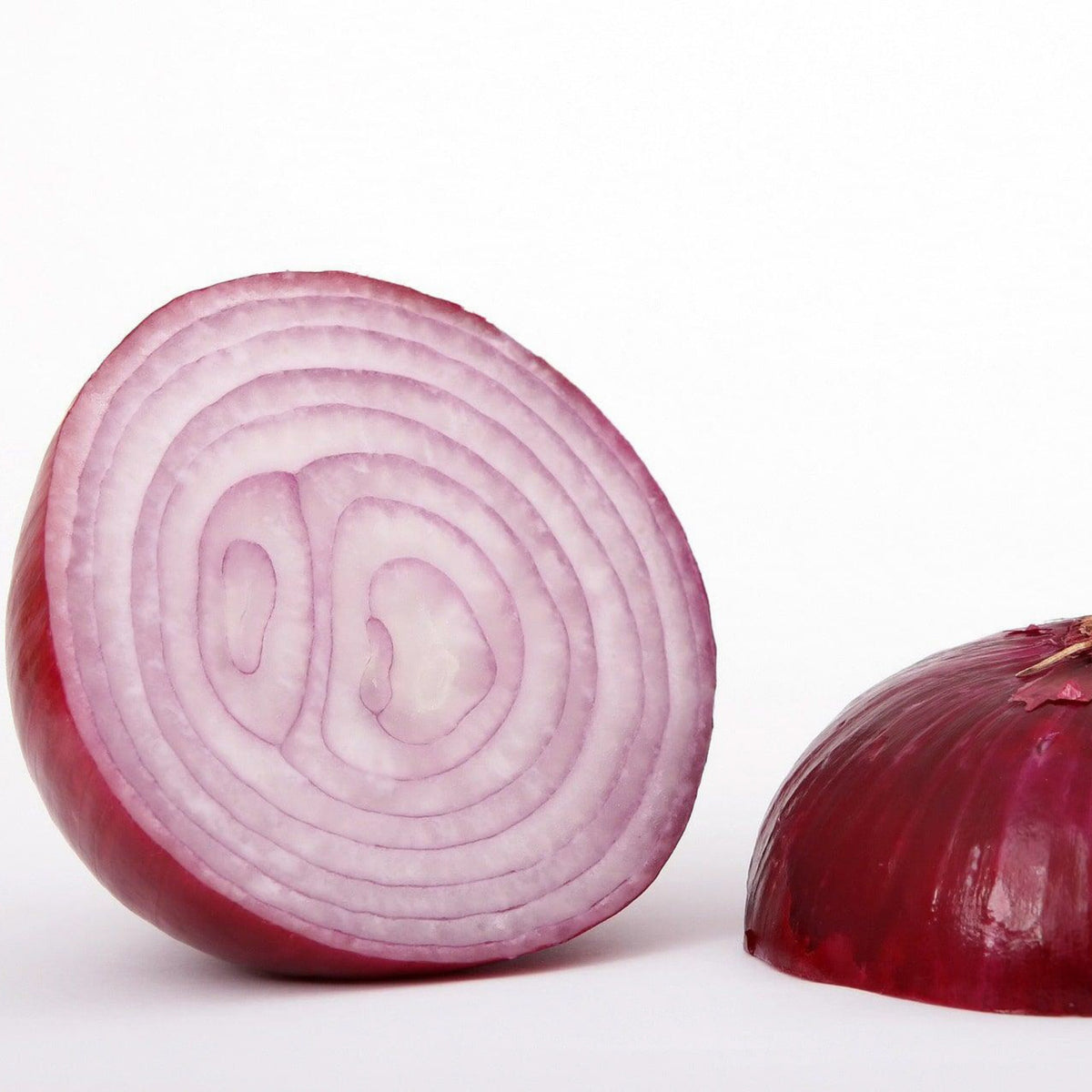 Southport Red Globe onion cut open showing red skin and purple-white rings